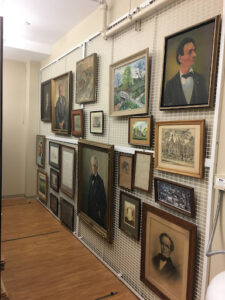 Crowded artwork displayed and stored in vertical storage in the new facility, circa 2017.